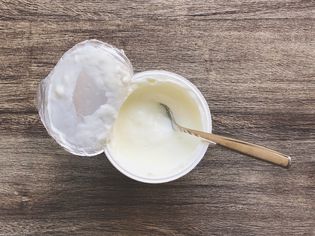a cup of yogurt on wood