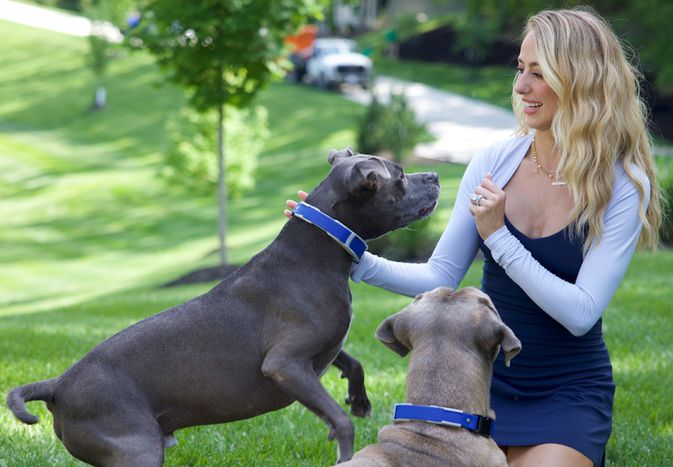 Brittany Mahomes spends time in yard with dogs Steel and Silver, am american pit bull terrier and a Cane Corso